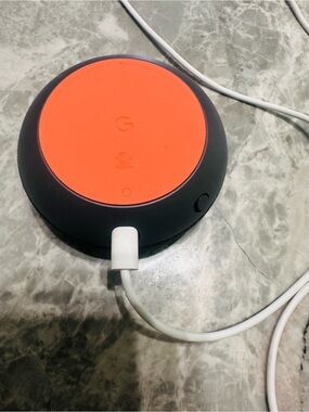 Google Smart Speaker with Bright Orange Top and Dark Gray Body